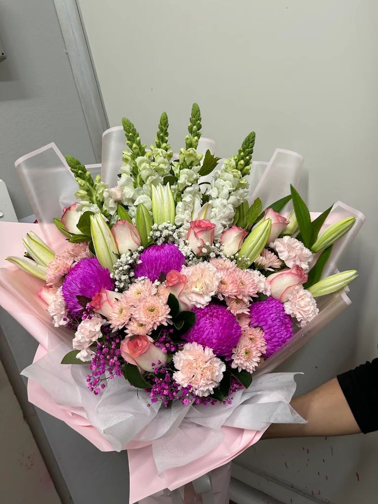 Bouquet of lilies, roses and purple chrysanthemums