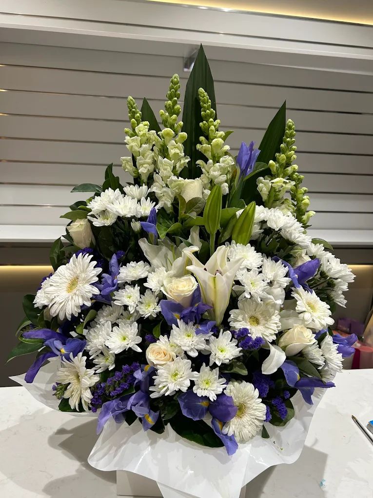 White and blue iris sympathy arrangement