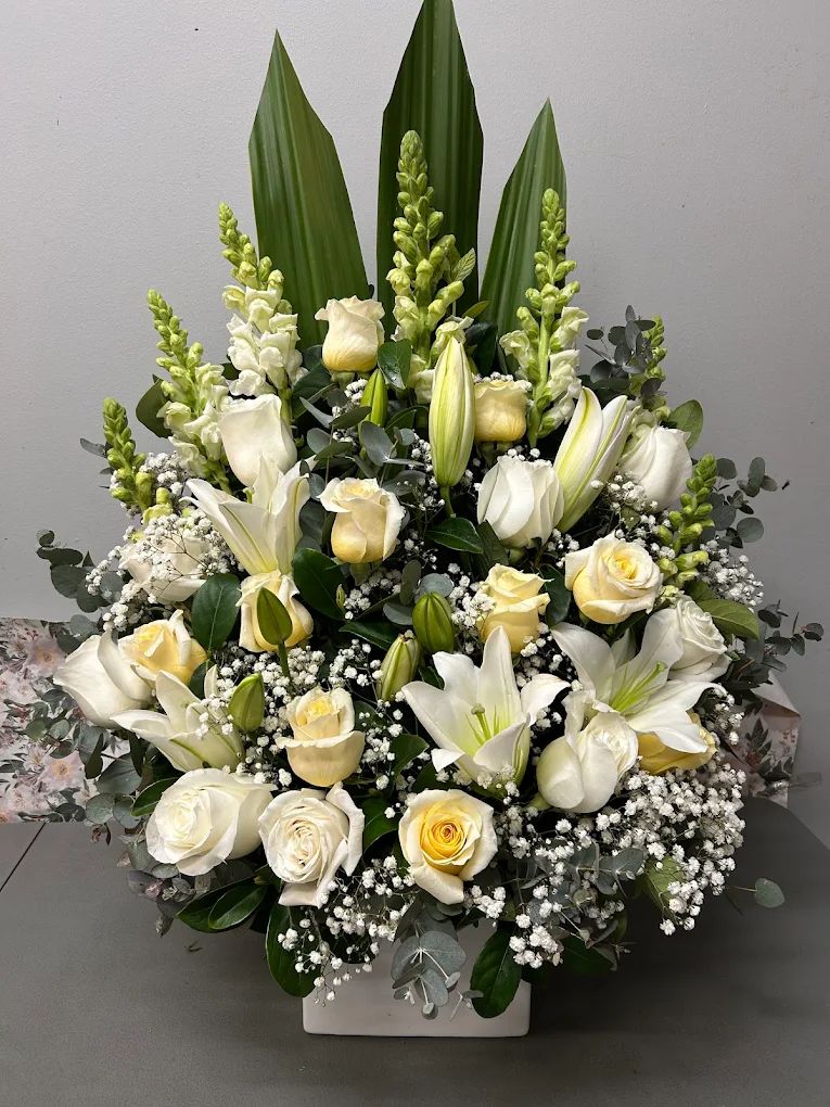 White lilies and roses sympathy arrangement