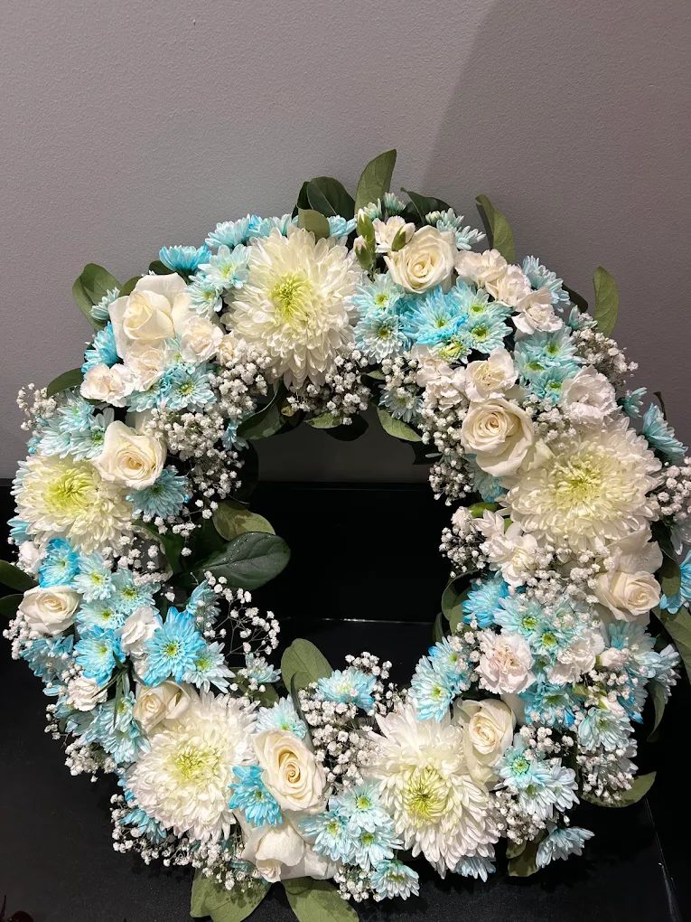 Wreath of white roses and blue chrysanthemums